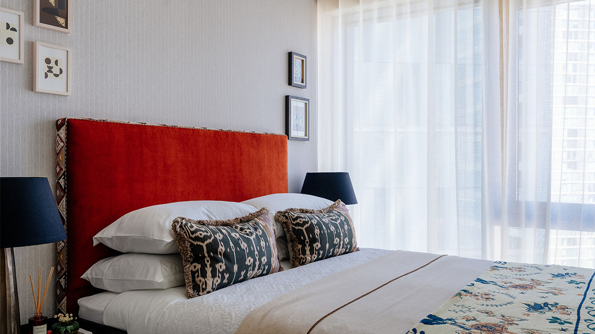 Stylish bedroom with a bold headboard and sheer curtains